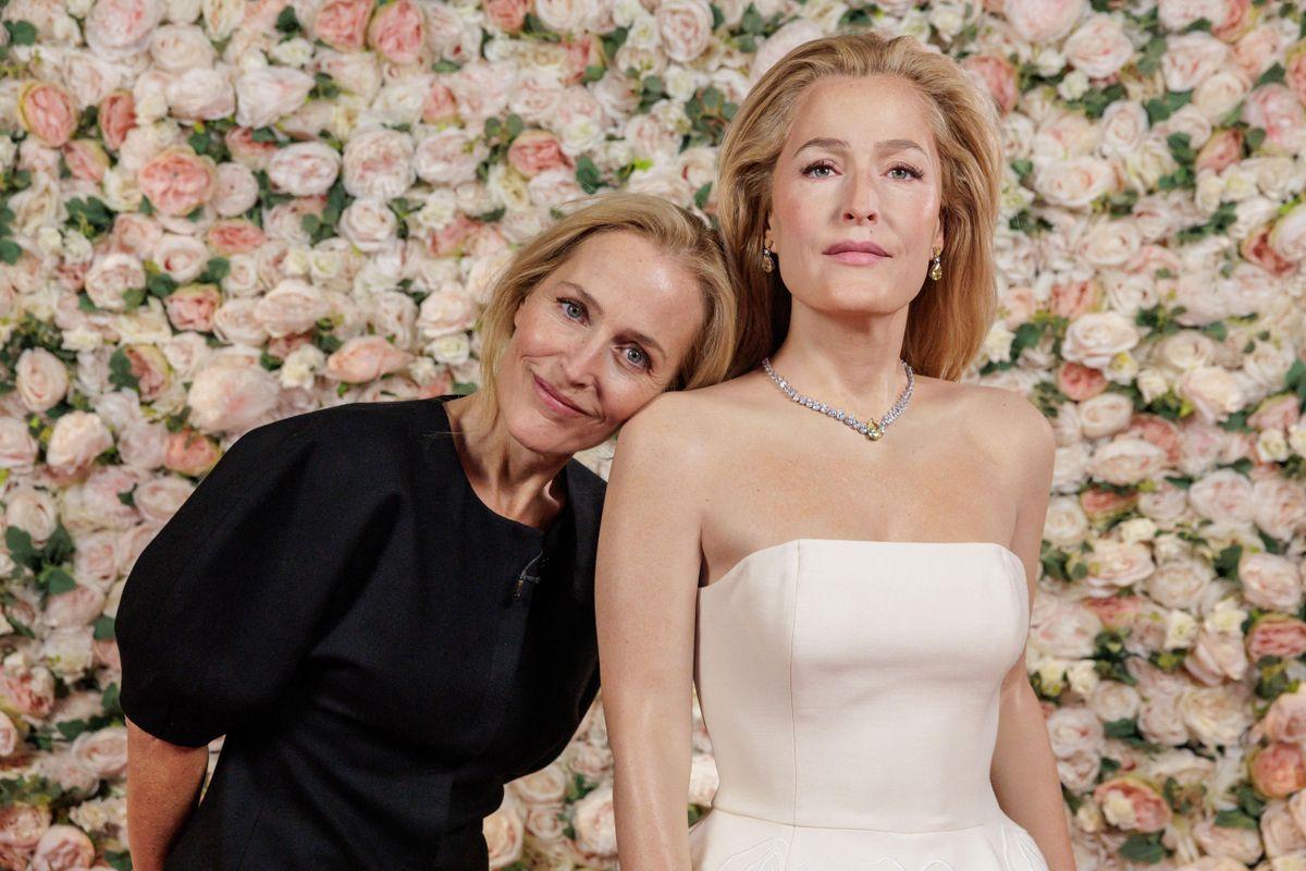 Gillian Anderson looked thrilled as she met her new Madame Tussauds London wax figure., The X-Files and The Crown actress came face to face with the amazing wax likeness, which wears her iconic "Vulva" dress from the 2024 Golden Globe Awards., The Gabriela Hearst-designed dress provided one of Gillian's most talked-about fashion moments and was donated to Madame Tussauds by Hearst herself., The figure's red carpet look is complete with diamante jewellery, metallic Aquazzura platform heels and a matching bag., Gillian said: "When I got the call from Madame Tussauds to say they wanted to create a wax figure of me, I thought, 'Really? Who would want to see a figure of me on a carpet rather than as a character?', "Then I thought about this dress and realized, yes, it makes sense to re-create this moment at the Golden Globes., "The dress became a much bigger conversation than even I had anticipated, with so many people reacting positively for different reasons., "I think this dress represents empowerment for women, celebrating bodily autonomy and freedom from shame. I wanted to give people the chance to stand next to it and revel in the audacity of it.”, Madame Tussauds London’s expert artists worked closely in collaboration with Gillian over the past year to create her first-ever Madame Tussauds figure, from taking precise measurements to capturing reference photographs and working together on deciding the look, pose and styling., The figure will feature in Madame Tussauds London’s iconic Awards Party zone, joining the star-studded line up of figures such as Bella Ramsey, Timothée Chalamet, Harry Styles, Zendaya, Dwayne Johnson, Priyanka Chopra Jonas and Lil Nas X., *MANDATORY BYLINE - MUST CREDIT: Madame Tussauds London/Mega. 26 Nov 2025 Pictured: Gillian Anderson. Photo credit: Madame Tussauds London/Mega TheMegaAgency.com sales@mega.global
